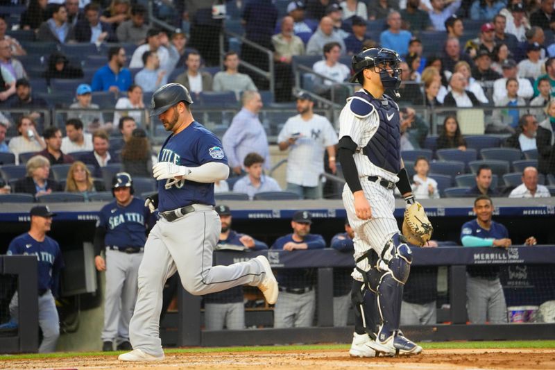 Jun 22, 2023; Bronx, New York, USA; Seattle Mariners designated hitter Mike Ford (20) scores a run on Seattle Mariners second baseman Jose Caballero (not pictured) sacrifice fly ball against the New York Yankees during the second inning at Yankee Stadium. Mandatory Credit: Gregory Fisher-USA TODAY Sports