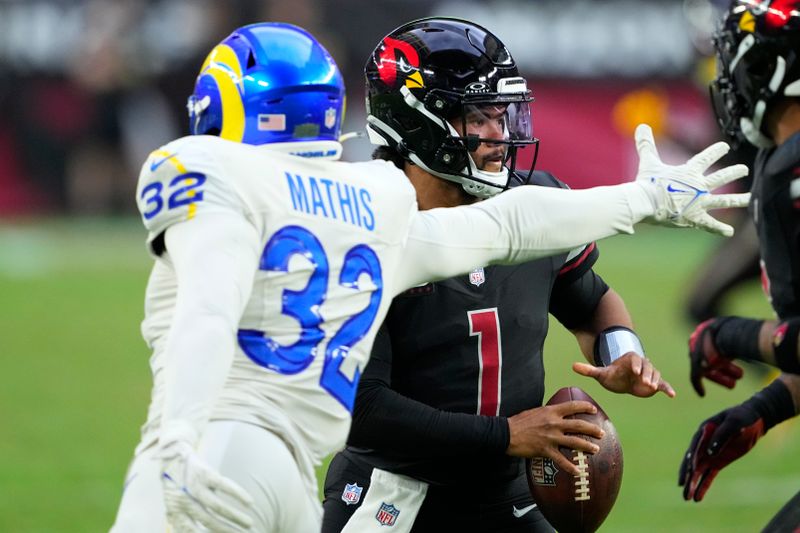 Arizona Cardinals quarterback Kyler Murray (1) tries to get away from Los Angeles Rams linebacker Ochaun Mathis during the second half of an NFL football game, Sunday, Nov. 26, 2023, in Glendale, Ariz. (AP Photo/Matt York)