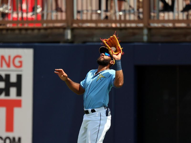 Mar 18, 2024; Port Charlotte, Florida, USA;  Tampa Bay Rays right fielder Amed Rosario (10) catches a fly ball during the fourth inning against the Atlanta Braves  at Charlotte Sports Park. Mandatory Credit: Kim Klement Neitzel-USA TODAY Sports