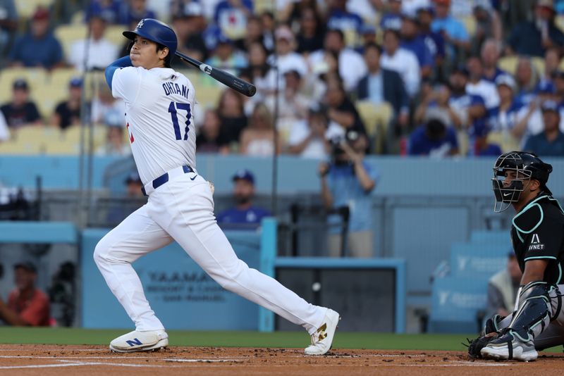 Jul 2, 2024; Los Angeles, California, USA;  Los Angeles Dodgers designated hitter Shohei Ohtani (17) hits a double during the first inning against the Arizona Diamondbacks at Dodger Stadium. Mandatory Credit: Kiyoshi Mio-USA TODAY Sports