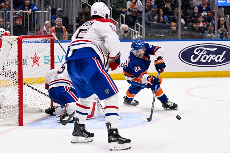 Apr 11, 2024; Elmont, New York, USA; New York Islanders center Kyle Palmieri (21) attempts a wrap a round on Montreal Canadiens goaltender Sam Montembeault (35) during the overtime period at UBS Arena. Mandatory Credit: Dennis Schneidler-USA TODAY Sports