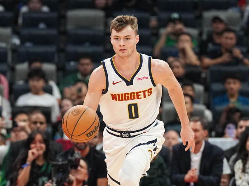 ABU DHABI, UAE - OCTOBER 6: Christian Braun #0 of the Denver Nuggets dribbles the ball during the game against the Boston Celtics during the 2024 Global Games on October 6, 2024 at the Etihad Arena in Abu Dhabi, United Arab Emirates. NOTE TO USER: User expressly acknowledges and agrees that, by downloading and/or using this Photograph, user is consenting to the terms and conditions of the Getty Images License Agreement. Mandatory Copyright Notice: Copyright 2024 NBAE (Photo by Garrett Ellwood/NBAE via Getty Images)