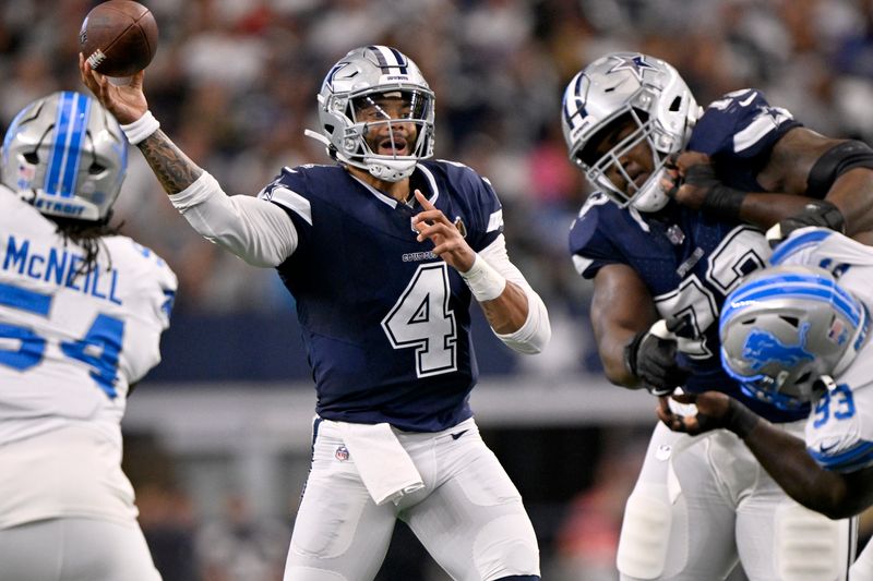 Dallas Cowboys quarterback Dak Prescott (4) throws a pass as the Detroit Lions rush in the first half of an NFL football game in Arlington, Texas, Sunday, Oct. 13, 2024. (AP Photo/Jerome Miron)