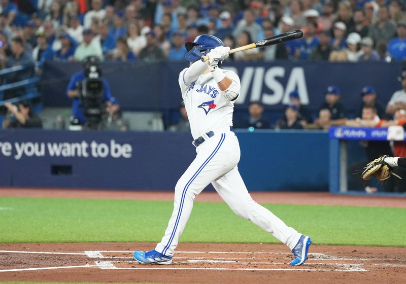 Jun 28, 2023; Toronto, Ontario, CAN; Toronto Blue Jays left fielder Whit Merrifield (15) hits an RBI double against the San Francisco Giants during the first inning at Rogers Centre. Mandatory Credit: Nick Turchiaro-USA TODAY Sports