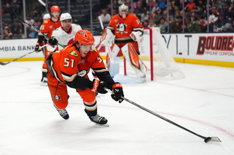 Nov 20, 2025; Anaheim, California, USA; Anaheim Ducks defenseman Olen Zellweger (51) reaches for the puck against the Ottawa Senators in the first period at Honda Center. Mandatory Credit: Kirby Lee-Imagn Images