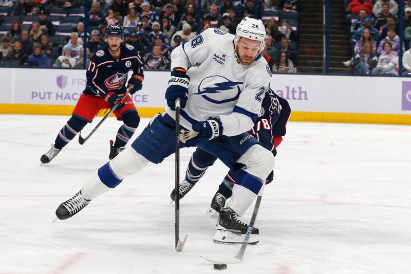 Nov 21, 2024; Columbus, Ohio, USA; Tampa Bay Lightning center Zemgus Girgensons (28) carries the puck past Columbus Blue Jackets defenseman Damon Severson (78) during the first period at Nationwide Arena. Mandatory Credit: Russell LaBounty-Imagn Images