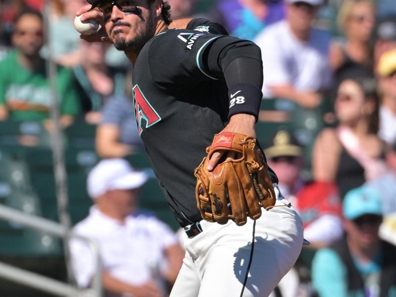 Feb 22, 2026; Salt River Pima-Maricopa, Arizona, USA; Arizona Diamondbacks third baseman Nolan Arenado (28) throws Los Angeles Angels outfielder Jose Siri (28) out at first in the third inning at Salt River Fields at Talking Stick. Mandatory Credit: Jayne Kamin-Oncea-Imagn Images