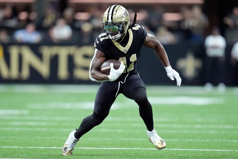 New Orleans Saints running back Alvin Kamara (41) runs against the Tampa Bay Buccaneers during the first half of an NFL football game in New Orleans, Sunday, Oct. 13, 2024. (AP Photo/Michael Conroy)