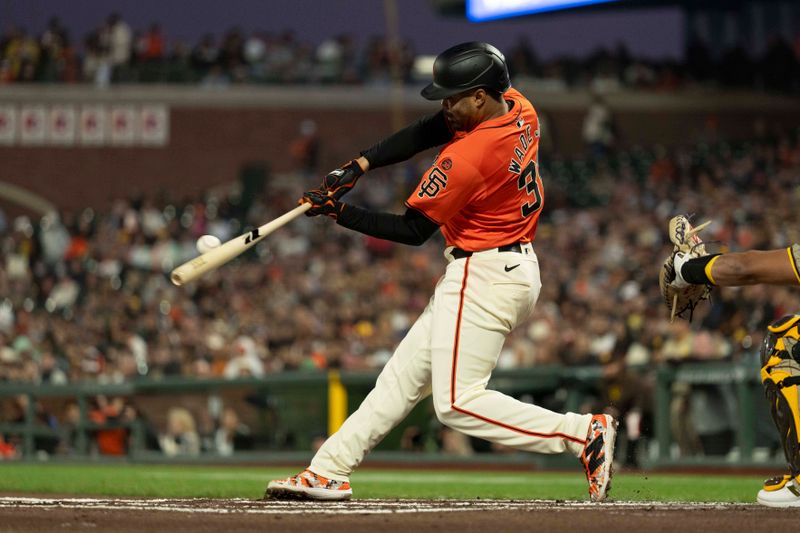 Sep 13, 2024; San Francisco, California, USA;  San Francisco Giants first base LaMonte Wade Jr. (31) hits a single during the first inning against the San Diego Padres at Oracle Park. Mandatory Credit: Stan Szeto-Imagn Images