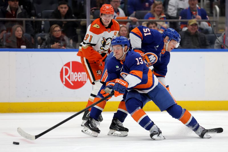 Dec 11, 2025; Elmont, New York, USA; New York Islanders center Mathew Barzal (13) plays the puck against Anaheim Ducks center Leo Carlsson (91) in front of Islanders left wing Emil Heineman (51) during the third period at UBS Arena. Mandatory Credit: Brad Penner-Imagn Images