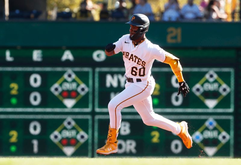 Oct 1, 2023; Pittsburgh, Pennsylvania, USA;  Pittsburgh Pirates shortstop Liover Peguero (60) runs the bases on a triple against the Miami Marlins during the second inning at PNC Park. Mandatory Credit: Charles LeClaire-USA TODAY Sports