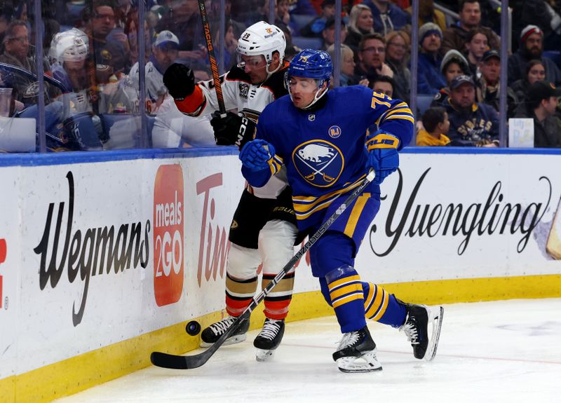 Feb 19, 2024; Buffalo, New York, USA;  Buffalo Sabres defenseman Connor Clifton (75) checks Anaheim Ducks center Sam Carrick (39) as he goes after a loose puck during the third period at KeyBank Center. Mandatory Credit: Timothy T. Ludwig-USA TODAY Sports