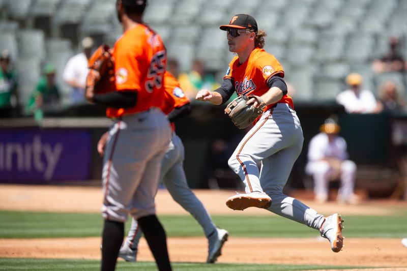 Jul 6, 2024; Oakland, California, USA; Baltimore Orioles shortstop Gunnar Henderson (2) leaves his feet to throw the ball home for a force out against the Oakland Athletics during the second inning at Oakland-Alameda County Coliseum. Mandatory Credit: D. Ross Cameron-USA TODAY Sports