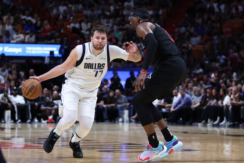 MIAMI, FLORIDA - APRIL 10: Luka Doncic #77 of the Dallas Mavericks drives against Bam Adebayo #13 of the Miami Heat during the second quarter of the game at Kaseya Center on April 10, 2024 in Miami, Florida. NOTE TO USER: User expressly acknowledges and agrees that, by downloading and or using this photograph, User is consenting to the terms and conditions of the Getty Images License Agreement. (Photo by Megan Briggs/Getty Images)