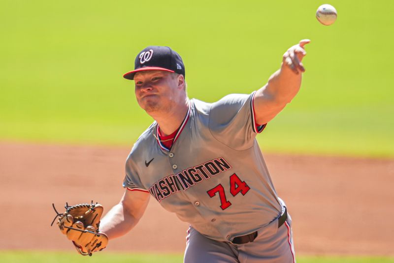 Aug 25, 2024; Cumberland, Georgia, USA; Washington Nationals starting pitcher DJ Herz (74) pitches against the Atlanta Braves during the first inning at Truist Park. Mandatory Credit: Dale Zanine-USA TODAY Sports