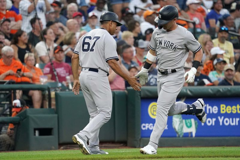 Jul 30, 2023; Baltimore, Maryland, USA; New York Yankees outfielder Jake Bauers (61) greeted by coach Luis Rojas (67) following his solo home run in the third inning against the Baltimore Orioles at Oriole Park at Camden Yards. Mandatory Credit: Mitch Stringer-USA TODAY Sports