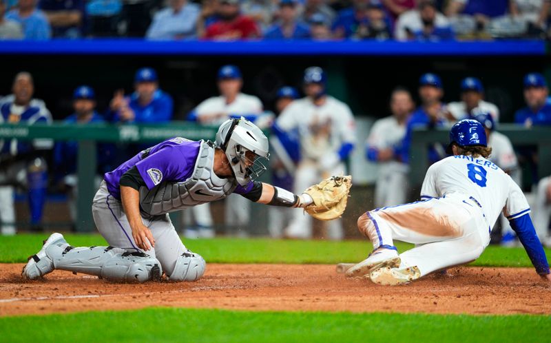 Apr 22, 2025; Kansas City, Missouri, USA; Kansas City Royals right fielder Drew Waters (8) scores a run against Colorado Rockies catcher Jacob Stallings (25) during the eighth inning at Kauffman Stadium. Mandatory Credit: Jay Biggerstaff-Imagn Images