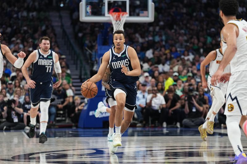 DALLAS, TX - MARCH 17: Dante Exum #0 of the Dallas Mavericks handles the ball during the game against the Denver Nuggets on March 17, 2024 at the American Airlines Center in Dallas, Texas. NOTE TO USER: User expressly acknowledges and agrees that, by downloading and or using this photograph, User is consenting to the terms and conditions of the Getty Images License Agreement. Mandatory Copyright Notice: Copyright 2024 NBAE (Photo by Glenn James/NBAE via Getty Images)