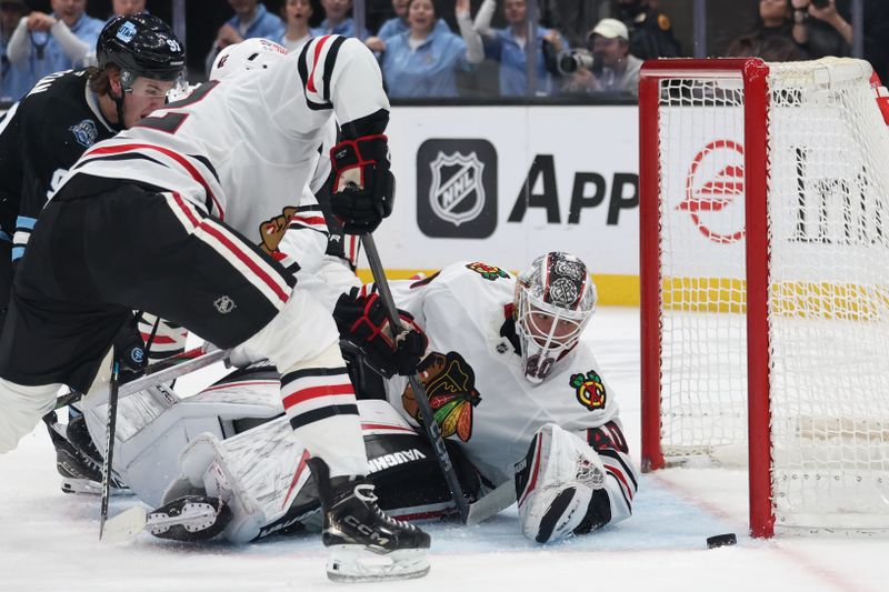 Feb 25, 2025; Salt Lake City, Utah, USA; Chicago Blackhawks goaltender Arvid Soderblom (40) watches a shot by Utah Hockey Club right wing Josh Doan (91) hit the post during the second period at Delta Center. Mandatory Credit: Rob Gray-Imagn Images