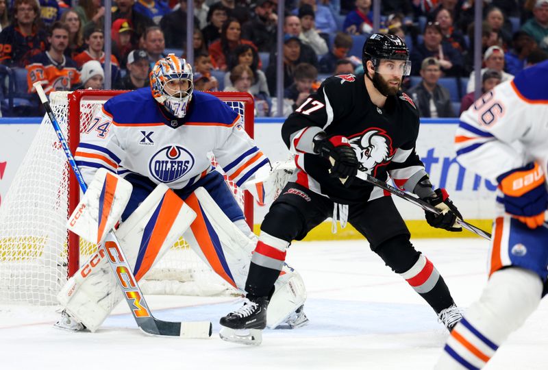 Mar 10, 2025; Buffalo, New York, USA;  Edmonton Oilers goaltender Stuart Skinner (74) and Buffalo Sabres left wing Jason Zucker (17) look for the puck during the second period at KeyBank Center. Mandatory Credit: Timothy T. Ludwig-Imagn Images