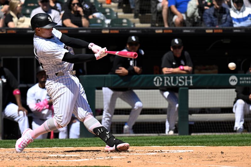 May 11, 2025; Chicago, Illinois, USA;  Chicago White Sox first base Andrew Vaughn (25) hits an RBI single against the Miami Marlins during the third inning at Rate Field. Mandatory Credit: Matt Marton-Imagn Images