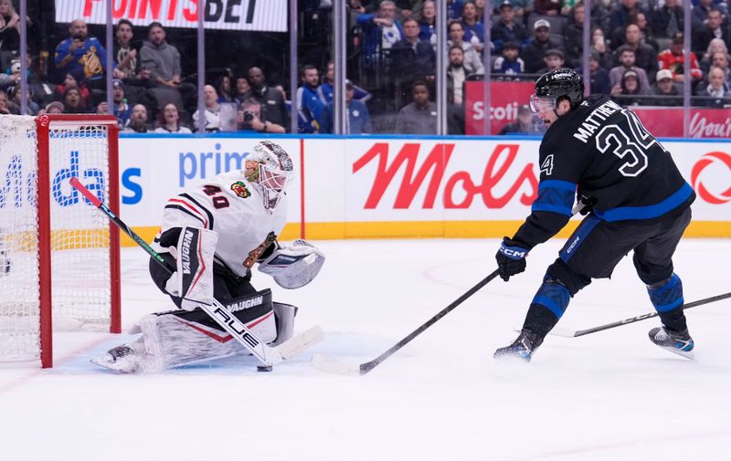Dec 2, 2024; Toronto, Ontario, CAN; Toronto Maple Leafs forward Auston Matthews (34) scores on Chicago Blackhawks goaltender Arvid Soderblom (40) during the first period at Scotiabank Arena. Mandatory Credit: John E. Sokolowski-Imagn Images