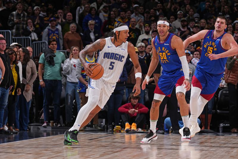 DENVER, CO - JANUARY 5: Paolo Banchero #5 of the Orlando Magic dribbles the ball during the game against the Denver Nuggets on January 5, 2024 at the Ball Arena in Denver, Colorado. NOTE TO USER: User expressly acknowledges and agrees that, by downloading and/or using this Photograph, user is consenting to the terms and conditions of the Getty Images License Agreement. Mandatory Copyright Notice: Copyright 2024 NBAE (Photo by Bart Young/NBAE via Getty Images)