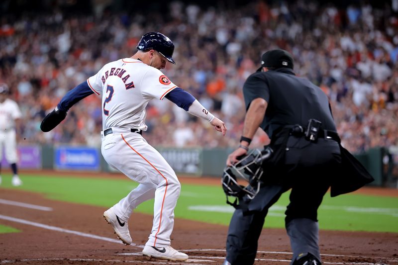 Jul 13, 2024; Houston, Texas, USA; Houston Astros third baseman Alex Bregman (2) crosses home plate to score a run against the Texas Rangers during the first inning at Minute Maid Park. Mandatory Credit: Erik Williams-USA TODAY Sports