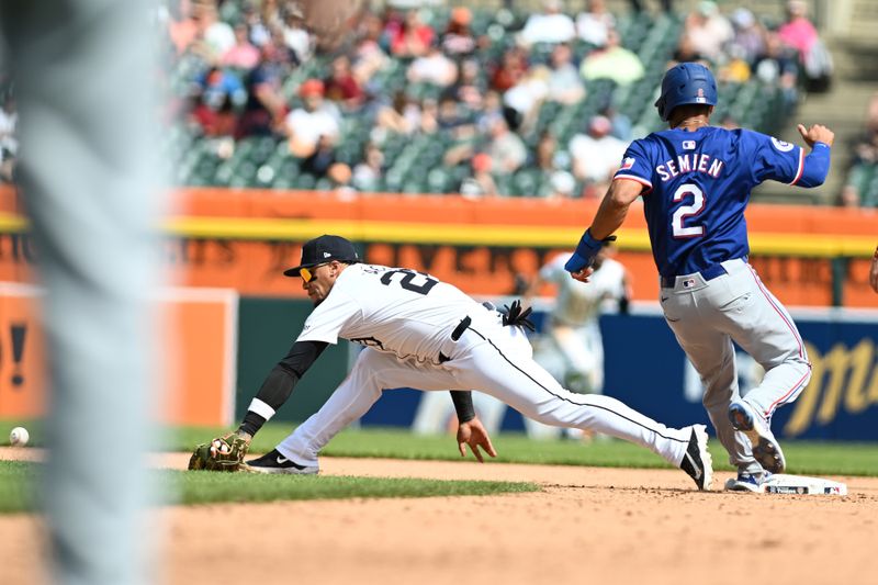 Apr 18, 2024; Detroit, Michigan, USA;  Texas Rangers second base Marcus Semien (2) runs safely into second base after a throw to Detroit Tigers shortstop Javier Baez (28) goes wide of the base in the seventh inning at Comerica Park. Mandatory Credit: Lon Horwedel-USA TODAY Sports