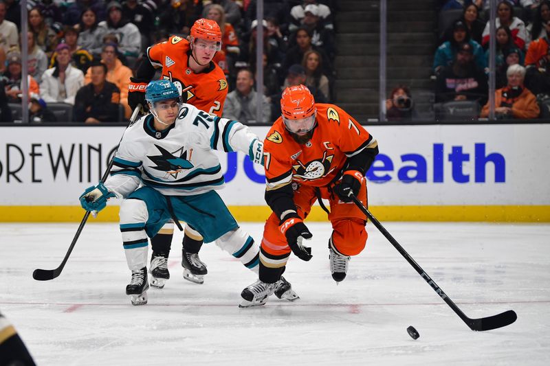 Oct 22, 2024; Anaheim, California, USA; Anaheim Ducks defenseman Radko Gudas (7) moves the puck ahead of San Jose Sharks left wing Danil Gushchin (75) during the third period at Honda Center. Mandatory Credit: Gary A. Vasquez-Imagn Images