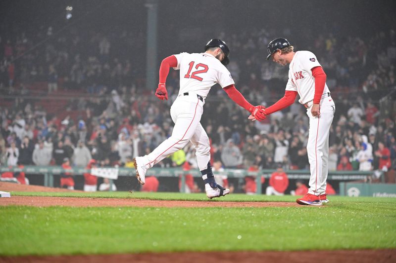 Apr 11, 20024; Boston, Massachusetts, USA; Boston Red Sox catcher Connor Wong (12) celebrates a home run against the Baltimore Orioles with third baseman coach Kyle Hudson (84) during the eighth inning at Fenway Park. Mandatory Credit: Eric Canha-USA TODAY Sports