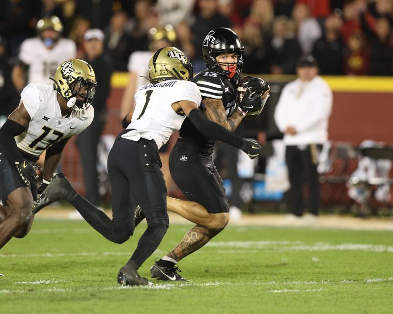 Oct 19, 2024; Ames, Iowa, USA; UCF Knights defensive back Ja'Cari Henderson (1) tackles Iowa State Cyclones wide receiver Jaylin Noel (13) at Jack Trice Stadium. The Cyclones beat the Knights 38 to 35.  Mandatory Credit: Reese Strickland-Imagn Images