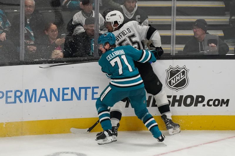 Nov 25, 2024; San Jose, California, USA; San Jose Sharks center Macklin Celebrini (71) checks Los Angeles Kings right winger Quinton Byfield (55) in the third period at SAP Center at San Jose. Mandatory Credit: David Gonzales-Imagn Images