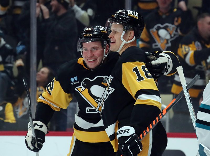 Nov 16, 2024; Pittsburgh, Pennsylvania, USA;  Pittsburgh Penguins right wing Jesse Puljujarvi (18) celebrates with right wing Sam Poulin (22) after scoring a goal against the San Jose Sharks during the first period at PPG Paints Arena. Mandatory Credit: Charles LeClaire-Imagn Images