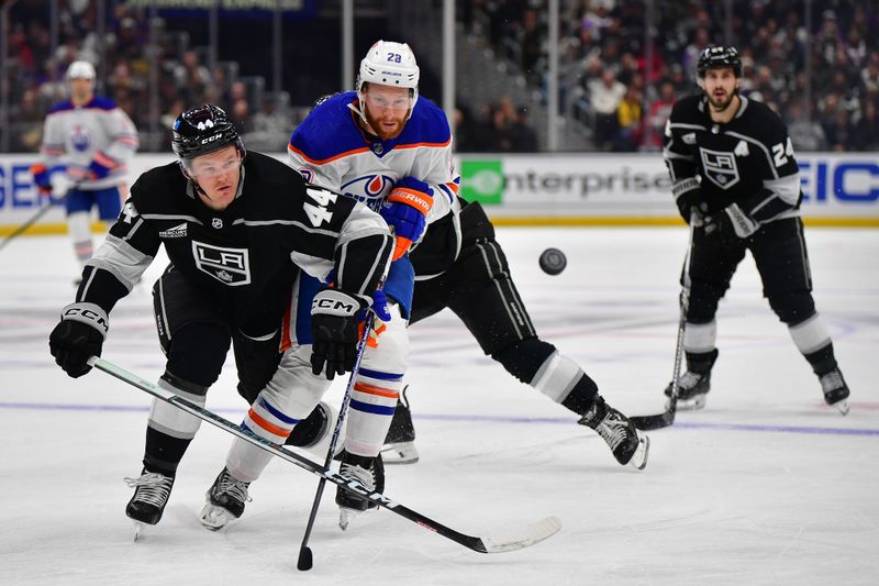 Dec 30, 2023; Los Angeles, California, USA; Los Angeles Kings defenseman Mikey Anderson (44) plays for the puck against Edmonton Oilers right wing Connor Brown (28) during the third period at Crypto.com Arena. Mandatory Credit: Gary A. Vasquez-USA TODAY Sports