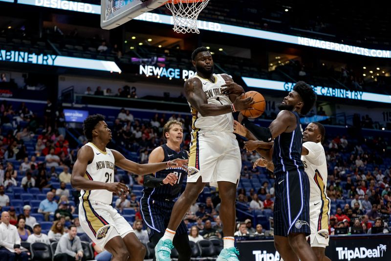 NEW ORLEANS, LOUISIANA - OCTOBER 7:  Zion Williamson #1 of the New Orleans Pelicans and Jonathan Isaac #1 of the Orlando Magic battle for a rebound during the first half of a preseason game at the Smoothie King Center on October 7, 2024 in New Orleans, Louisiana. NOTE TO USER: User expressly acknowledges and agrees that, by downloading and or using this photograph, User is consenting to the terms and conditions of the Getty Images License Agreement. (Photo by Derick E. Hingle/Getty Images)