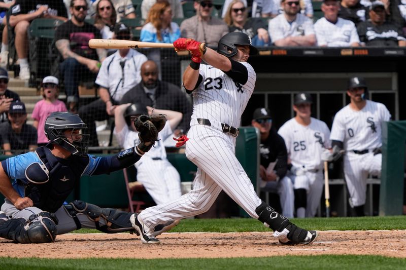 Apr 28, 2024; Chicago, Illinois, USA; Chicago White Sox outfielder Andrew Benintendi (23) hits a two-RBI single against the Tampa Bay Rays during the eighth inning at Guaranteed Rate Field. Mandatory Credit: David Banks-USA TODAY Sports