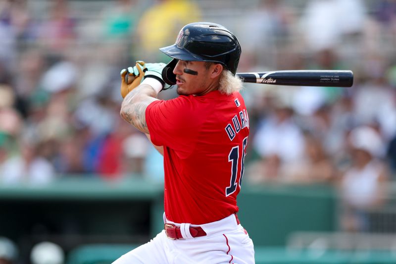 Mar 17, 2024; Fort Myers, Florida, USA;  Boston Red Sox left fielder Jarren Duran (16) doubles against the New York Yankees in the first inning at JetBlue Park at Fenway South. Mandatory Credit: Nathan Ray Seebeck-USA TODAY Sports