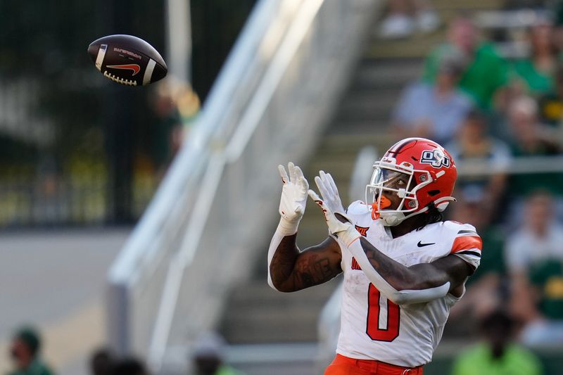 Oct 26, 2024; Waco, Texas, USA;  Oklahoma State Cowboys running back Ollie Gordon II (0) makes a catch against the Baylor Bears during the first half at McLane Stadium. Mandatory Credit: Chris Jones-Imagn Images