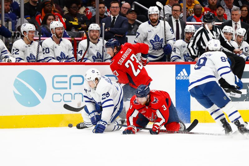 Mar 20, 2024; Washington, District of Columbia, USA; Toronto Maple Leafs right wing Pontus Holmberg (29) battles for the puck with Washington Capitals center Michael Sgarbossa (23) and Capitals defenseman Nick Jensen (3) during the third period at Capital One Arena. Mandatory Credit: Amber Searls-USA TODAY Sports