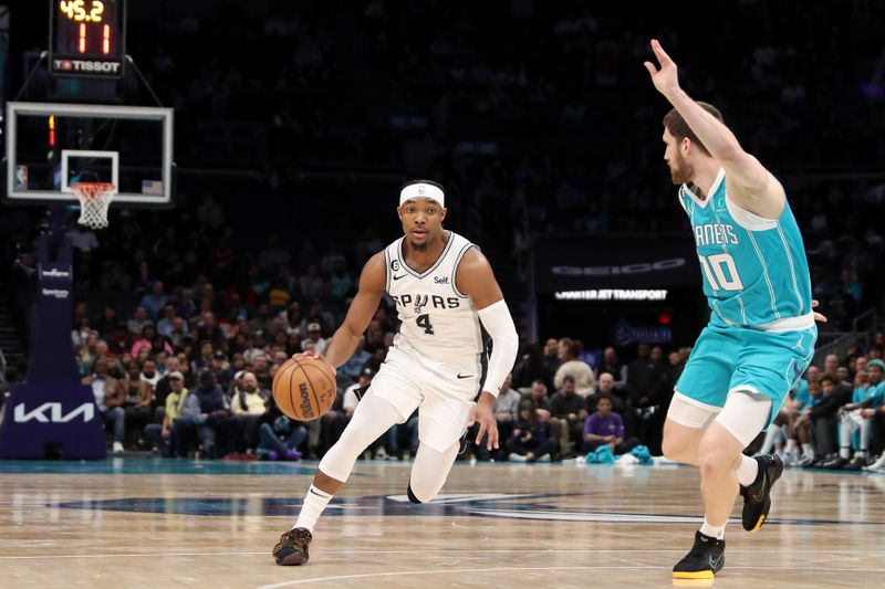 CHARLOTTE, NC - FEBRUARY 15: Devonte' Graham #4 of the San Antonio Spurs drives to the basket during the game against the Charlotte Hornets on February 15, 2023 at Spectrum Center in Charlotte, North Carolina. NOTE TO USER: User expressly acknowledges and agrees that, by downloading and or using this photograph, User is consenting to the terms and conditions of the Getty Images License Agreement.  Mandatory Copyright Notice:  Copyright 2023 NBAE (Photo by Brock Williams-Smith/NBAE via Getty Images)