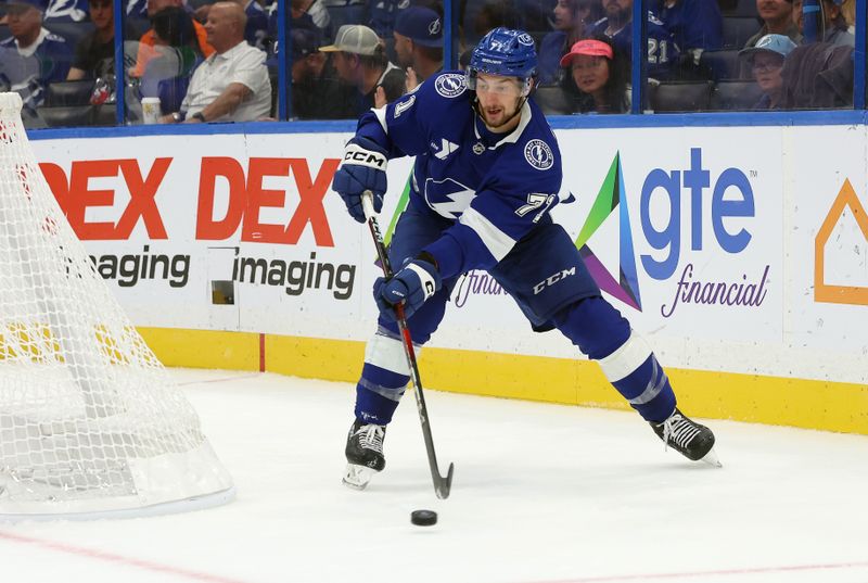 Oct 15, 2024; Tampa, Florida, USA; Tampa Bay Lightning center Anthony Cirelli (71) passes the puck against the Vancouver Canucks during the third period at Amalie Arena. Mandatory Credit: Kim Klement Neitzel-Imagn Images