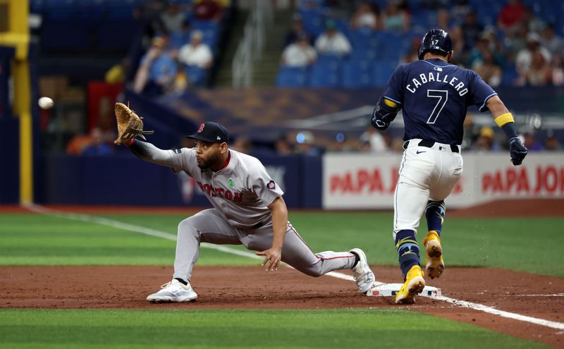 May 20, 2024; St. Petersburg, Florida, USA;  Boston Red Sox first base Dominic Smith (2) forces out Tampa Bay Rays shortstop José Caballero (7) during the third inning at Tropicana Field. Mandatory Credit: Kim Klement Neitzel-USA TODAY Sports