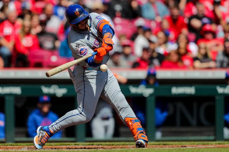 Apr 7, 2024; Cincinnati, Ohio, USA; New York Mets catcher Francisco Alvarez (4) hits a single against the Cincinnati Reds in the first inning at Great American Ball Park. Mandatory Credit: Katie Stratman-USA TODAY Sports