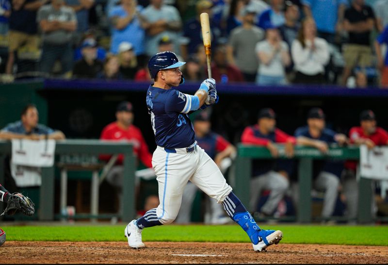 May 9, 2025; Kansas City, Missouri, USA; Kansas City Royals catcher Freddy Fermin (34) hits a walk-off single during the 12th inning against the Boston Red Sox at Kauffman Stadium. Mandatory Credit: Jay Biggerstaff-Imagn Images