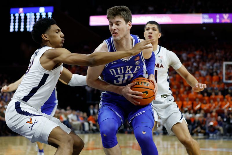 Feb 11, 2023; Charlottesville, Virginia, USA; Duke Blue Devils center Kyle Filipowski (30) drives to the basket as Virginia Cavaliers guard Ryan Dunn (13) defends in the first half at John Paul Jones Arena. Mandatory Credit: Geoff Burke-USA TODAY Sports