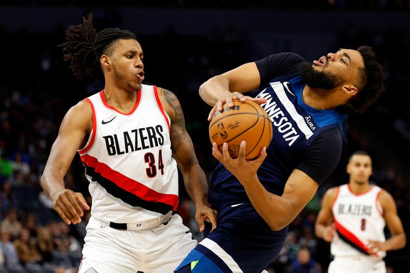 MINNEAPOLIS, MINNESOTA - MARCH 04: Karl-Anthony Towns #32 of the Minnesota Timberwolves draws a foul against Jabari Walker #34 of the Portland Trail Blazers in the third quarter at Target Center on March 04, 2024 in Minneapolis, Minnesota. The Timberwolves defeated the Trail Blazers 119-114. NOTE TO USER: User expressly acknowledges and agrees that, by downloading and or using this photograph, User is consenting to the terms and conditions of the Getty Images License Agreement. (Photo by David Berding/Getty Images)