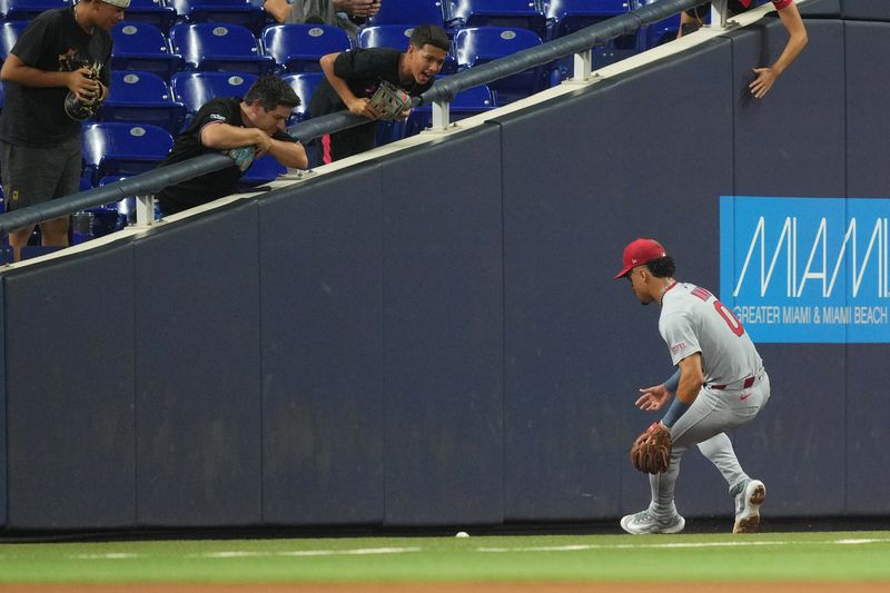 Aug 19, 2025; Miami, Florida, USA;  St. Louis Cardinals shortstop Masyn Winn (0) chases down an errant throw by pitcher Michael McGreevy (36) in the fourth inning that allowed a run to score for the Miami Marlins at loanDepot Park. Mandatory Credit: Jim Rassol-Imagn Images