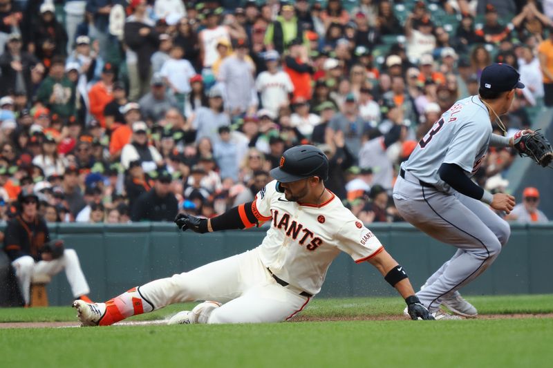 Aug 11, 2024; San Francisco, California, USA; San Francisco Giants left fielder Michael Conforto (8) slides safely to third base against Detroit Tigers third baseman Gio Urshela (13) during the sixth inning at Oracle Park. Mandatory Credit: Kelley L Cox-USA TODAY Sports