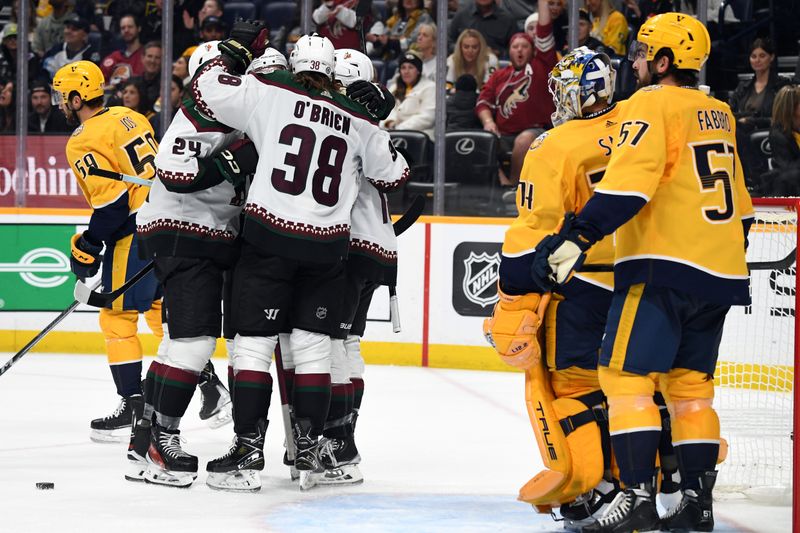 Nov 11, 2023; Nashville, Tennessee, USA; Arizona Coyotes players celebrate after a goal by center Alexander Kerfoot (15) during the second period against the Nashville Predators at Bridgestone Arena. Mandatory Credit: Christopher Hanewinckel-USA TODAY Sports